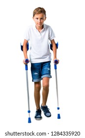 Little Kid With Crutches On Isolated White Background