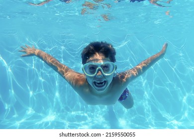 Little Kid Diving Into A Swimming Pool