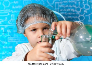 Little kid doing experiments with blue liquid. Cute child wants to become a doctor. Pretty child in white medical robe holds glass flasks with blue liquid on indigo background with hospital symbol. - Shutterstock ID 2258410939