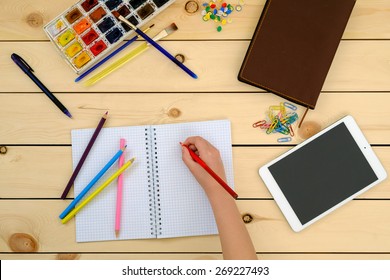 Little Kid Doing Homework In Notebook - Top View  