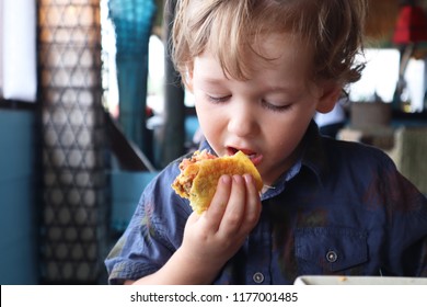 Little Kid Eating Taco On A Restaurant In The Beach, Okinawa Japan