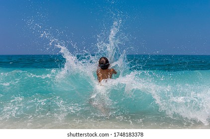 Little kid enjoying the waves on the beach