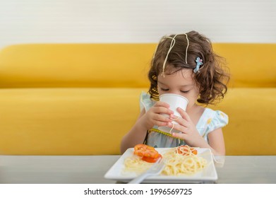 Little Kid Enjoys Eating Spagetti And Drinking Some Water By Herself 