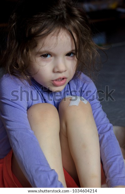 Little Kid Girl Band On Knee Stock Photo (Edit Now) 1034604214