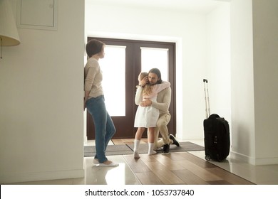 Little Kid Girl Embracing Dad Leaving Family Moving Out With Travel Case, Sad Daughter Hugging Father In House Hall Saying Goodbye To Daddy Going Away, Unhappy Child Of Divorced Parents Concept