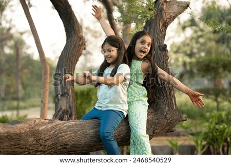 Similar – Image, Stock Photo Cute little girl having fun on outdoor playground. Spring or summer active sport leisure for kids. Child on plastic swing