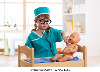 Little kid girl playing doctor in playschool