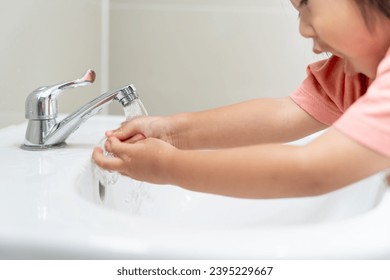 little kid hands wash with soap bubbles and rinse with clean water to prevent and stop the spread of germs after back to home, virus or covid19. Good health and good personal hygiene, virus, bacteria - Shutterstock ID 2395229667