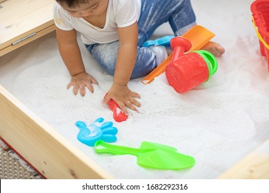 A Little Kid Have Fun When He Play Sand In The Backyard.