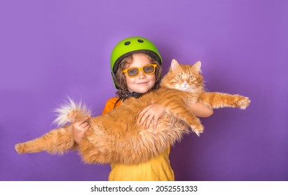 Little Kid Holding Big Ginger Cat. Owner Of Pet Holding Funny Overweight Cat Isolated On Colorful Background. Big Fluffy Orange Cat Lying On The Hands.