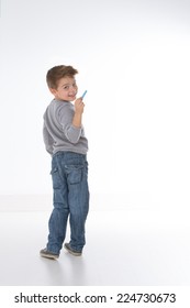 little kid intends to write something on empty wall