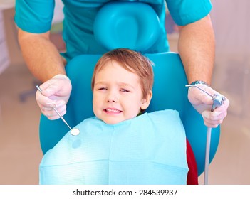 little kid, patient afraid of dentist while visiting dental clinic - Powered by Shutterstock