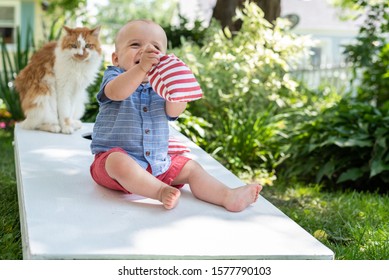 Little Kid Playing Cornhole With Family In Backyard On Fourth Of July