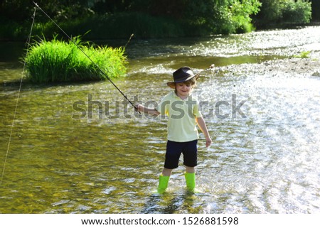 Little kid pulling fishing rod while fishing on weekend. Boy fish in pond. Little boy fishing alone. Kids Fishing. Little Boy Catching a Fish