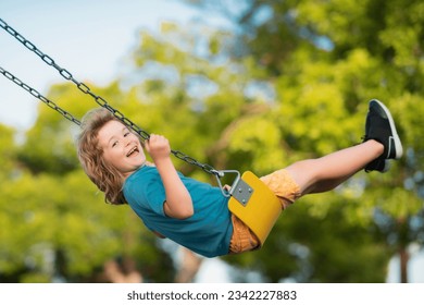 Little kid swinging portrait. Adorable child having fun on a swing on summer day. Happy dream. Dreamy kids face. Daydreamer child portrait close up. Dreams and imagination.