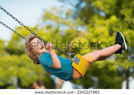 Little kid swinging portrait. Adorable child having fun on a swing on summer day. Happy dream. Dreamy kids face. Daydreamer child portrait close up. Dreams and imagination.
