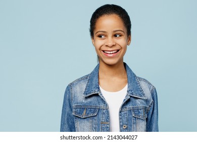 Little Kid Teen Girl Of African American Ethnicity 12-13 Years Old Wearing Denim Jacket Look Aside On Workspace Area Mock Up Isolated On Pastel Plain Light Blue Color Background. Childhood Concept.