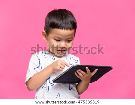 Little kid using dgital tablet