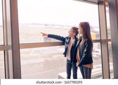 Little Kids In Airport Waiting For Boarding And Looking At Window On The Planes