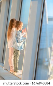 Little Kids In Airport Waiting For Boarding And Looking At Window On The Planes