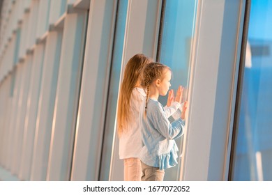 Little Kids In Airport Waiting For Boarding And Looking At Window On The Planes