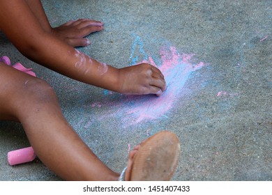 Little Kids Exploring Their Creativity On The Side Walk With A Variety Of Chalk In Madison, Wisconsin.