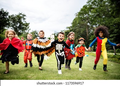 Little kids at a Halloween party - Shutterstock ID 1173596917