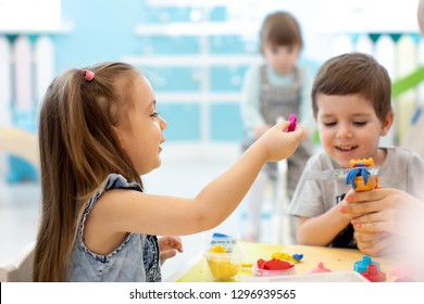 Little Kids Have A Fun Together With Colorful Modeling Clay At Daycare. Creative Kids Molding In Kindergarten. Children Girl And Boy Play With Plasticine Or Dough.