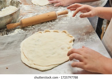 Little kids make dough products. Flour is scattered around. Hands close up. - Shutterstock ID 1725797788