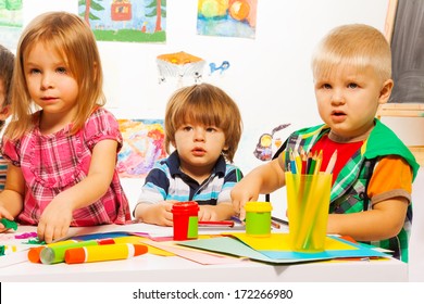 Little kids on painting class sitting together with pencils and paints - Shutterstock ID 172266980