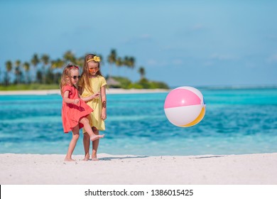 Little Kids Playing On White Beach With Air Ball