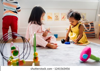 Little kids playing toys in the playroom