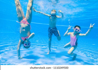 Little Kids Swimming  In Pool  Underwater.