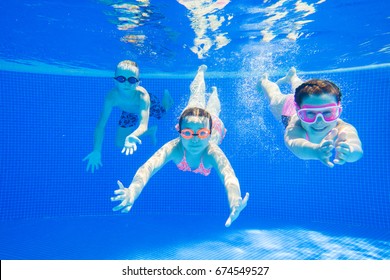 Little Kids Swimming  In Pool  Underwater.