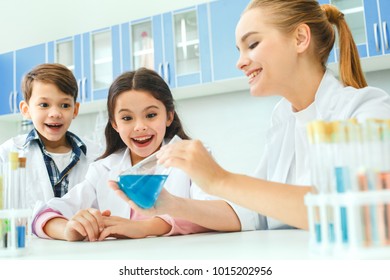 Little kids with teacher in school laboratory result - Powered by Shutterstock