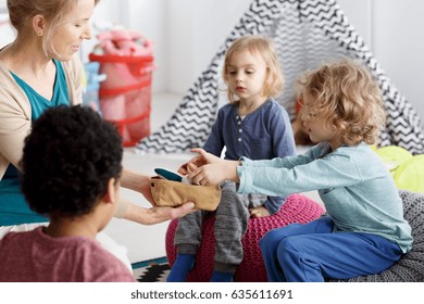 Little Kids And Their Teacher Cleaning Toys After Play
