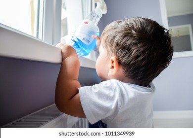 Little latin boy reaching a toxic cleaning product.