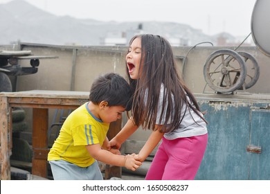 Little Latin Siblings Fighting Outside.