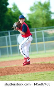 Little League Baseball Boy Pitching During A Game.