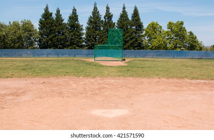 Little League Baseball Field With Green Grass, Brown Dirt And No People