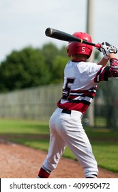 Little League Baseball Player Getting Ready To Swing The Bat.