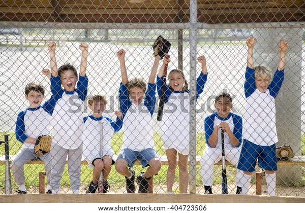Little
league baseball team cheering behind wire
fence