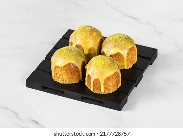 Little Lemon cakes with icing sugar, on a wooden stand. Light background	 - Shutterstock ID 2177728757