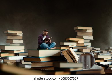 Little Man Reading Among Large Books And Textbooks