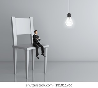 Little Man Sitting A Big Chair And Lamp