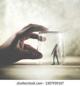 little man trapped in a glass, surreal concept - Shutterstock ID 1307939107