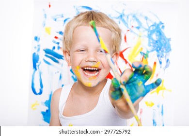 Little Messy Kid Painting With Paintbrush Picture On Easel. Education. Creativity. School. Preschool. Studio Portrait Over White Background.