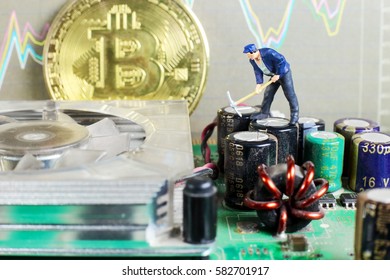 A little miner is digging for bitcoin on graphic card with chart background. conceptual image of crypto currency mining.