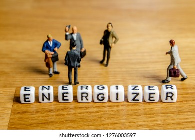 little miniature figurines with little dices forming specific word energizer as a part of team meeting collection pictures dedicated to one part of its time table on wooden background - Powered by Shutterstock