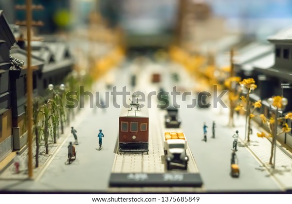 A little model of architecture and\
transportation of Japan, is showing in museum. They are very pretty\
and look like real city. There are little people and some cars and\
train. With blurry\
background.